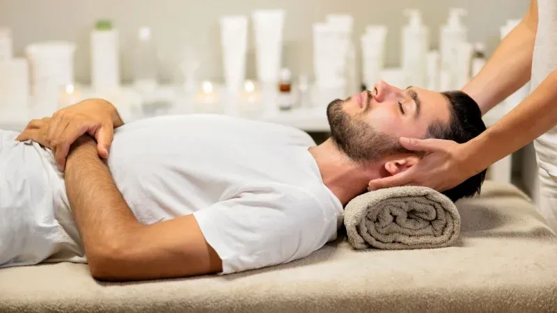 Man receiving a relaxing neck and head massage at Lotus Men’s Spa in Anantapur, surrounded by a calm and soothing spa atmosphere.