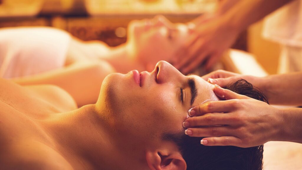 Man enjoying a relaxing head massage at Lotus Men’s Spa in Anantapur, experiencing calm and stress relief in a soothing spa environment.